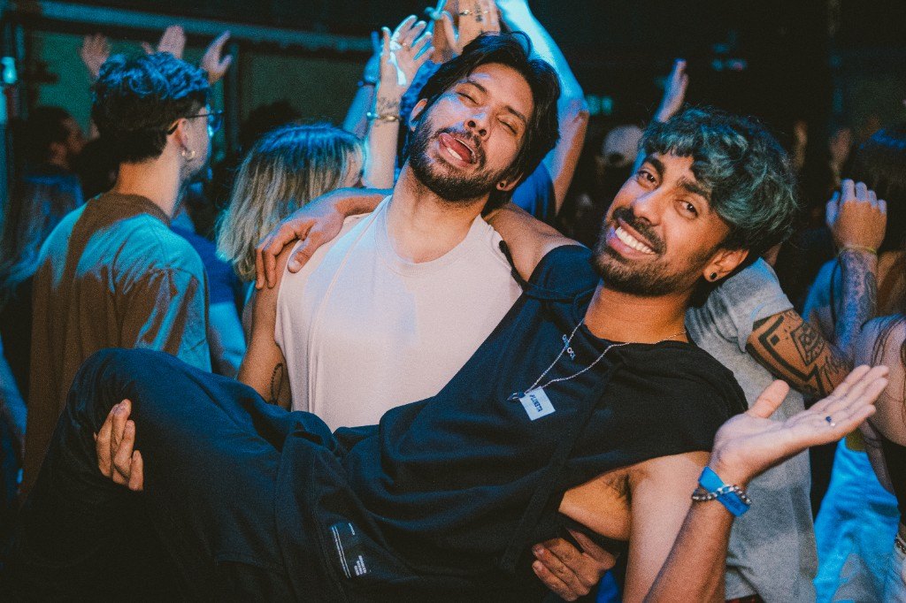 Integrantes da Kool Kids no meio da pista, com o público de mãos para cima.